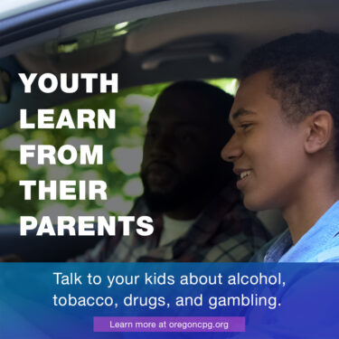 A teen boy being taught how to drive by his father. The captions reads, "Youth learn from their parents."
