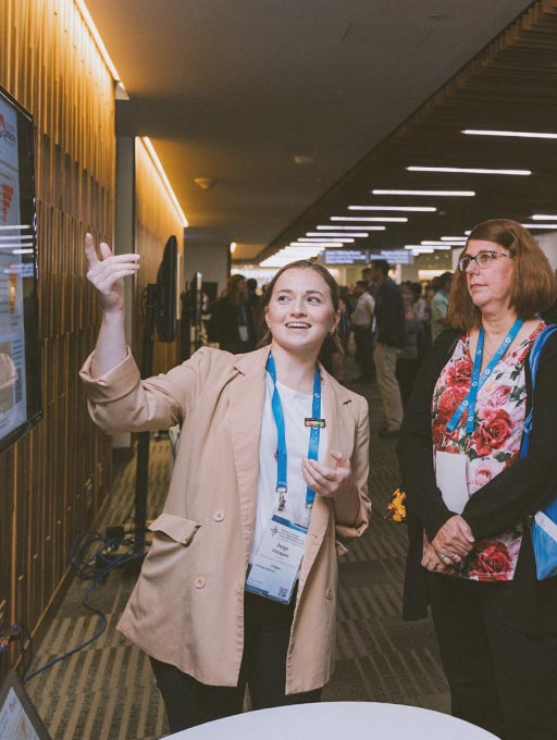 OCPG Research A young woman researcher gives a presentation at a conference